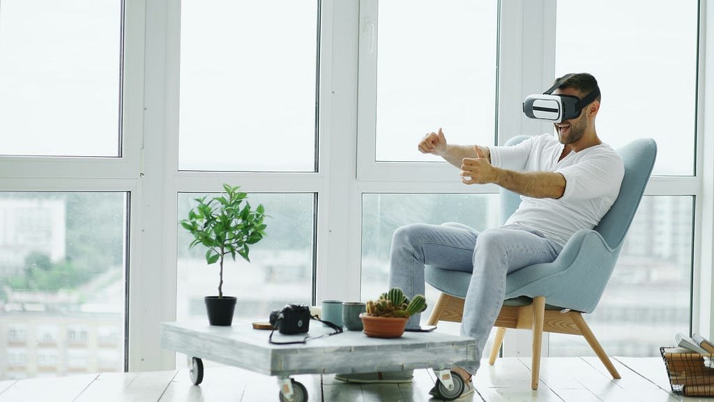 a guy using VR headset in a fancy living room