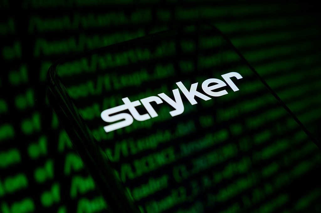 The Stryker Corporation logo appears on the screen of a smartphone